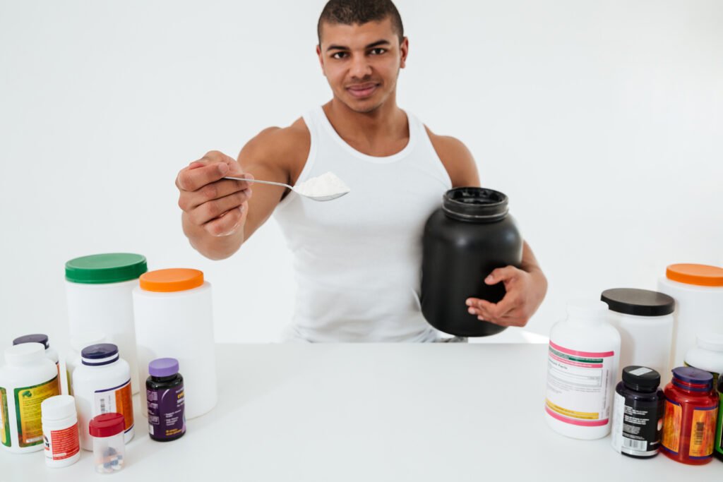 sportsman-standing-white-wall-holding-best weight loss supplements